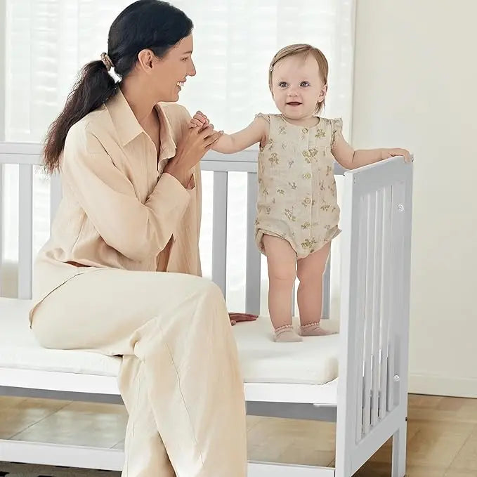 EvoNest 6-in-1 Portable Mini Crib with Mattress & 4 Height Adjustable, New Zealand Pinewood, White, MAMAZING